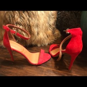 Red suede heel with ankle strap.